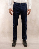 Model photo of men's navy blue stretch chino pants by DANTE.